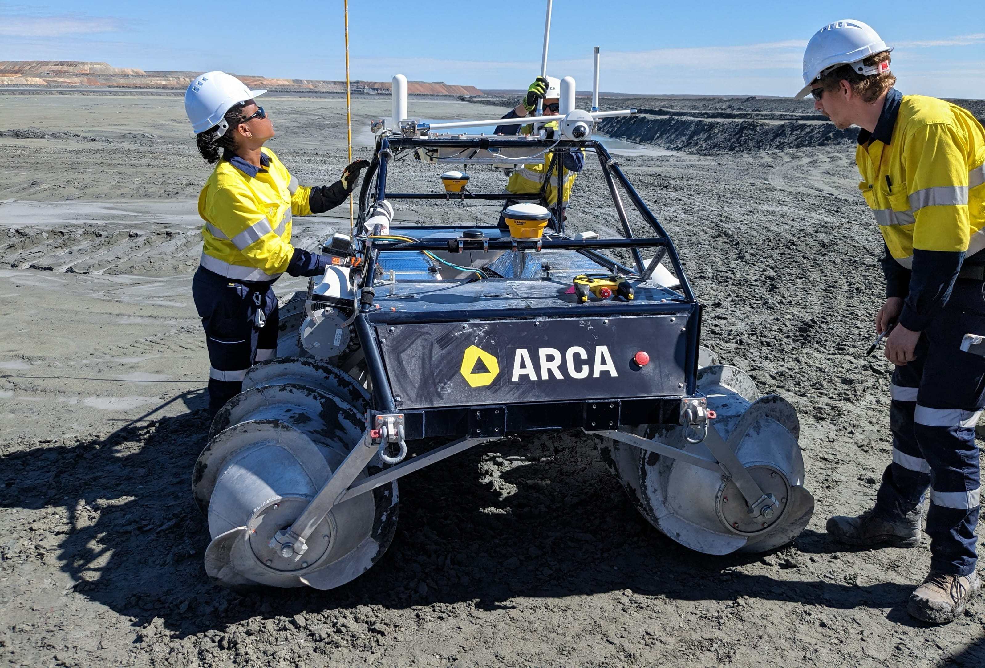 Arca scientists with rover at a mine tailings storage facility