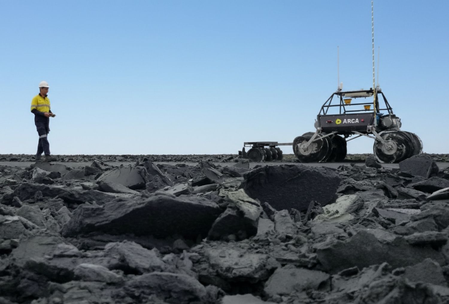 Scientist with rover at a mine site